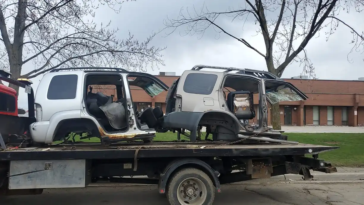 End-of-life car being collected for scrap vehicle recycling